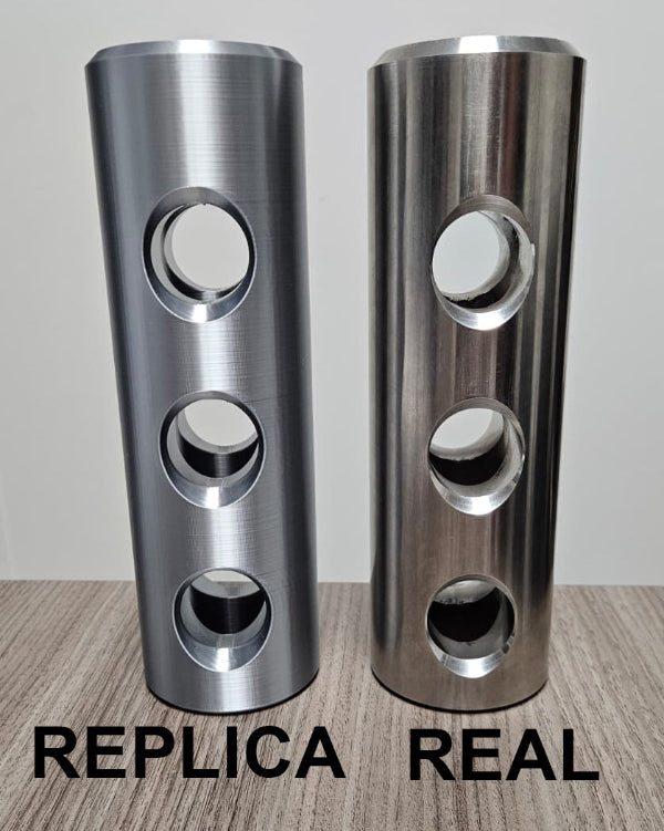 3D printed 30mm Bushmaster muzzle brake replica beside a real muzzle brake for comparison