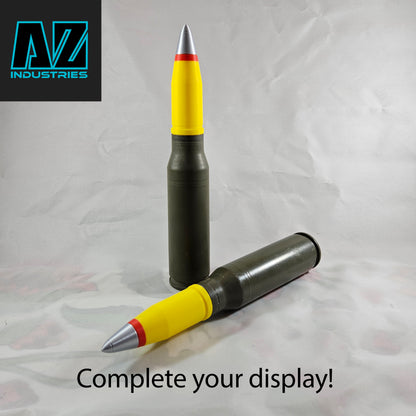 3D printed 25mm brass shell casing topper displayed on surface