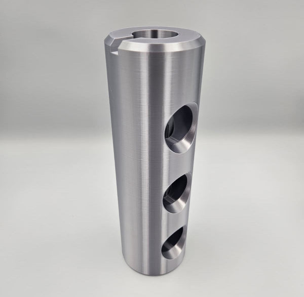 Front view of 3D printed AC-130J 30mm Bushmaster muzzle brake replica showing three side ports