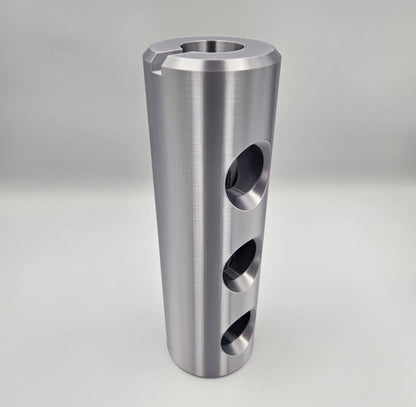 Front view of 3D printed AC-130J 30mm Bushmaster muzzle brake replica showing three side ports