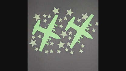 Glow-in-the-dark 3D printed military aircraft and star Stack Packs set displayed in low light